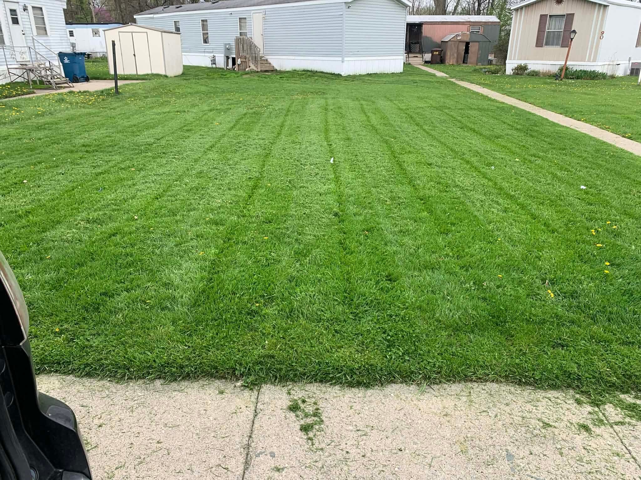 Pristine trailer park lawn with professional G&E stripes